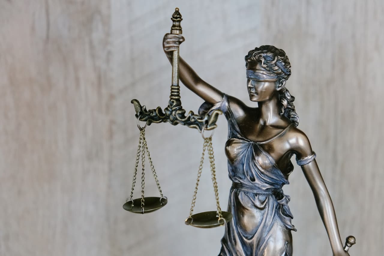 Scales of justice and legal gavel on a desk representing the American legal system and court proceedings
