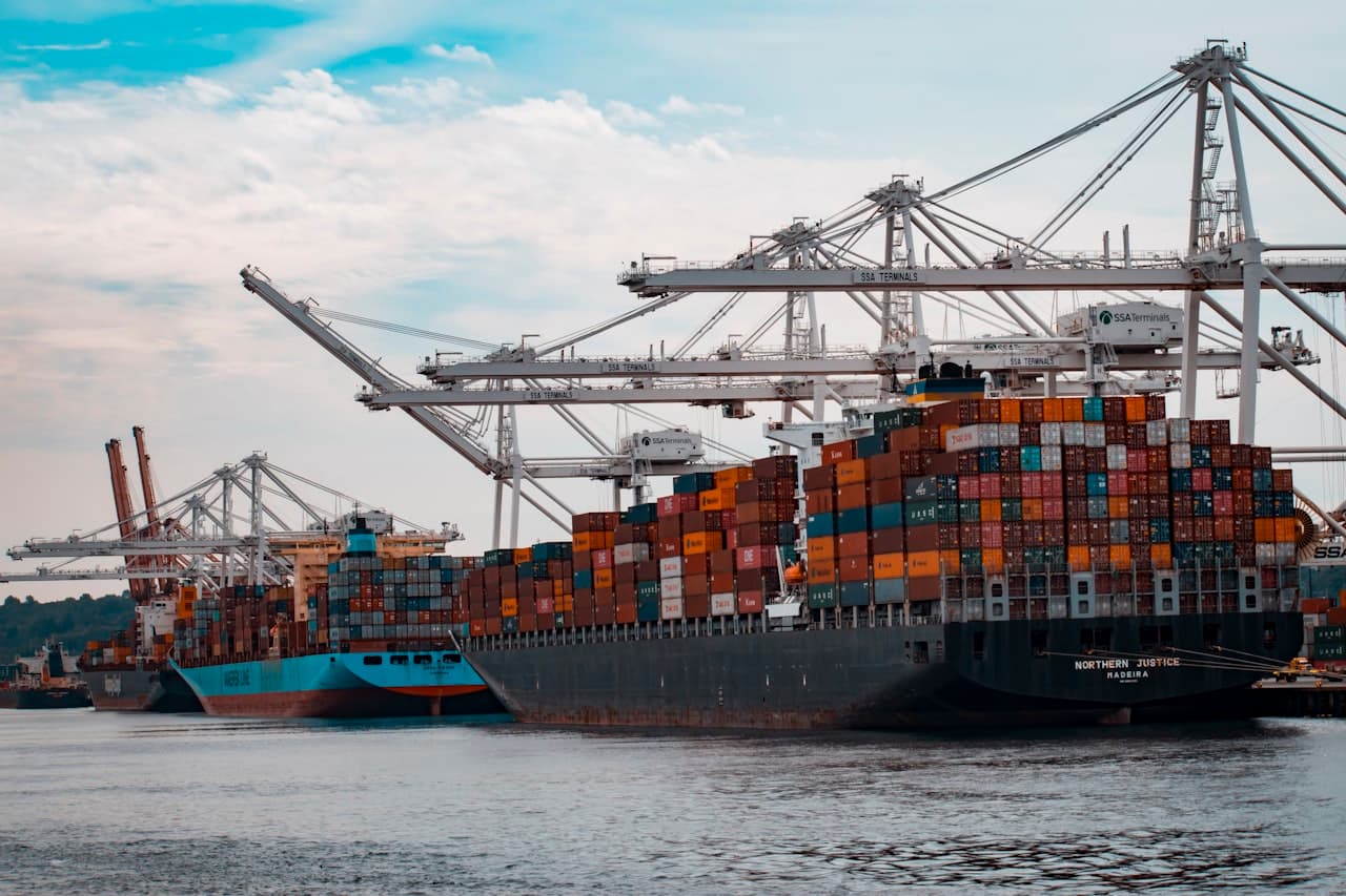 Colorful shipping containers stacked at a commercial port representing international trade and tariff policy